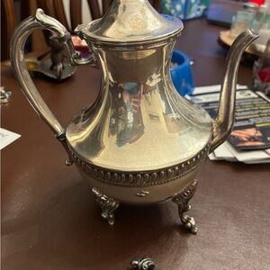 Elegant Silver Teapot with Ornate Legs